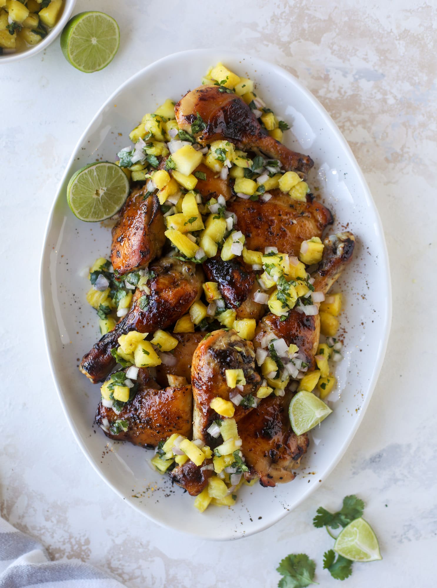 This sticky chicken recipe is made on a sheet pan and roasted until flavorfor and sticky with sauce, then served with pineapple salsa. It