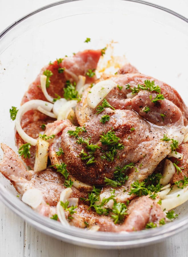 How To Cook Pork Shoulder Steak - raw pork steaks with marinade.