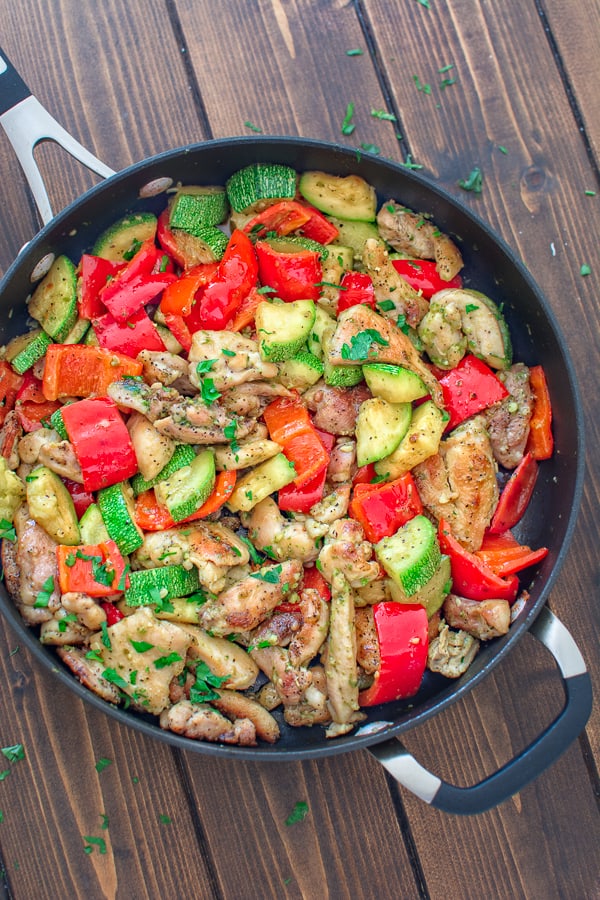 Pesto chicken thighs and veggies in a skillet