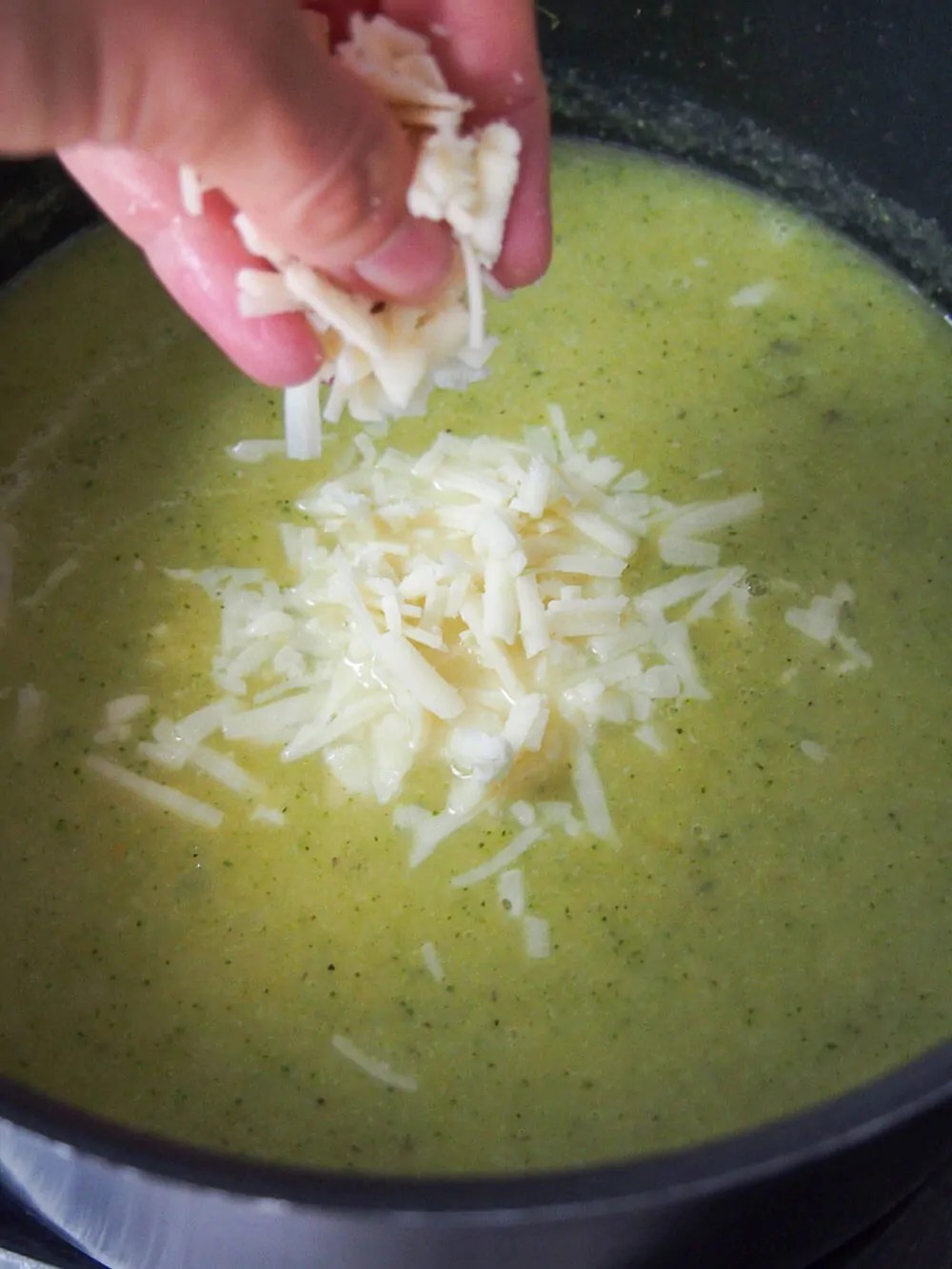 adding cheddar to Pumpkin broccoli soup with cheddar