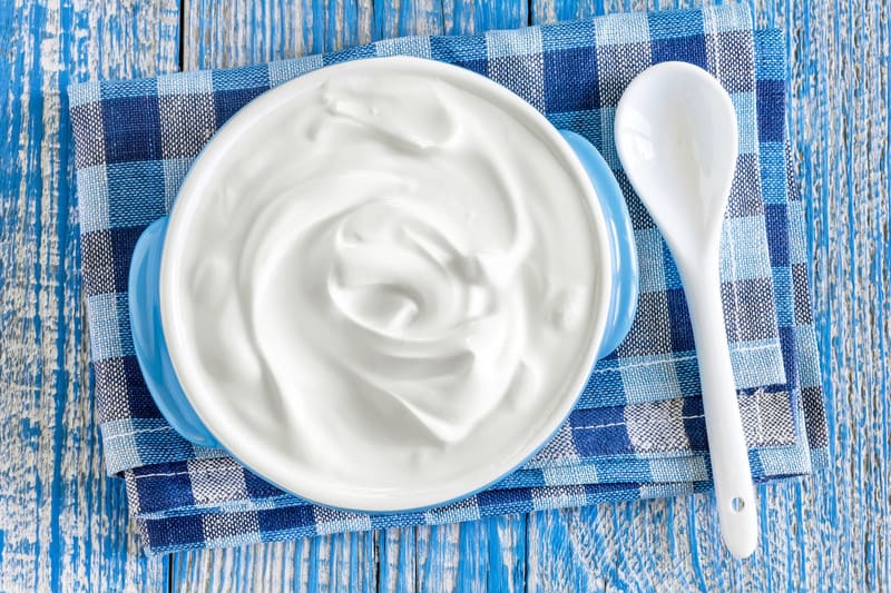 Sour cream on a blue table