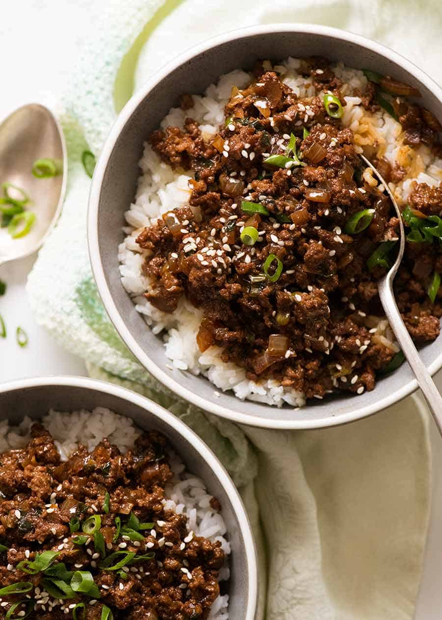 Overhead photo of Asian Ground Beef bowls served over rice in blue bowls